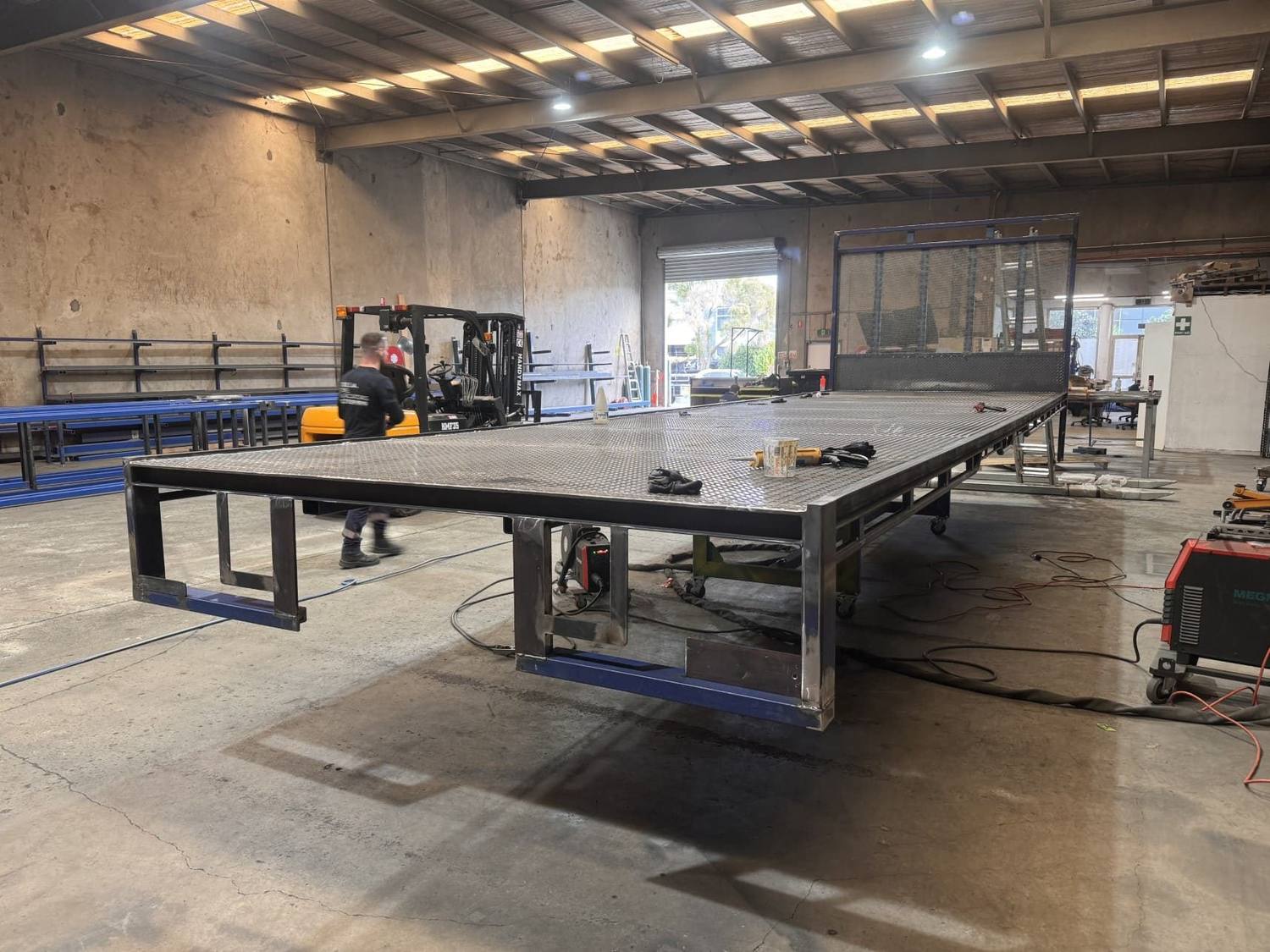 Large checker-plate truck tray under construction in the factory